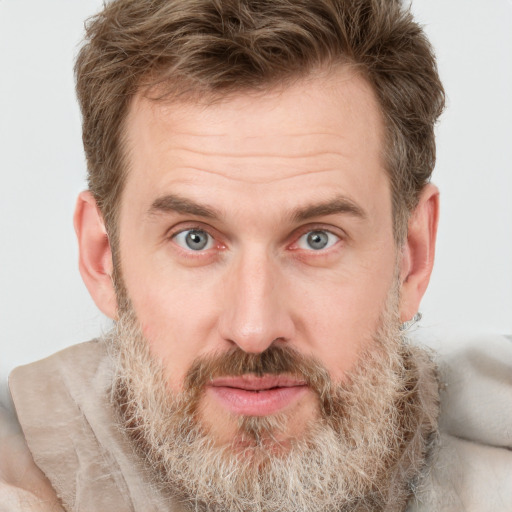 Joyful white adult male with short  brown hair and grey eyes