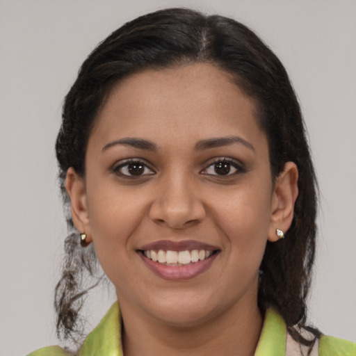 Joyful latino young-adult female with medium  brown hair and brown eyes