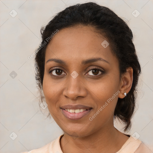 Joyful black adult female with medium  brown hair and brown eyes