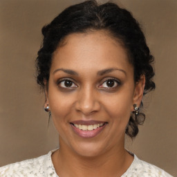 Joyful black young-adult female with medium  brown hair and brown eyes