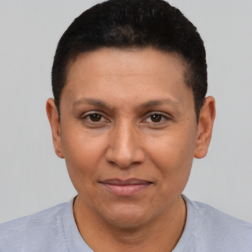 Joyful latino adult female with short  brown hair and brown eyes
