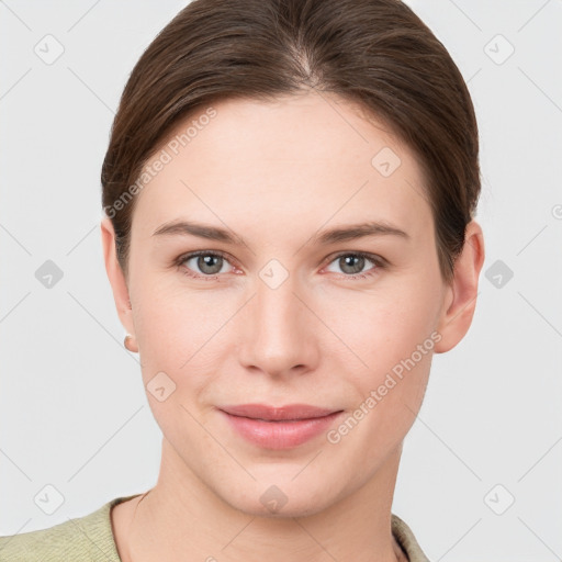 Joyful white young-adult female with short  brown hair and grey eyes