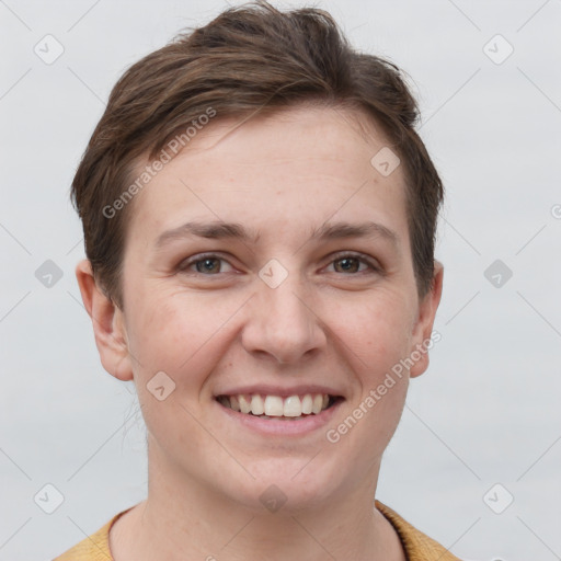 Joyful white young-adult female with short  brown hair and grey eyes