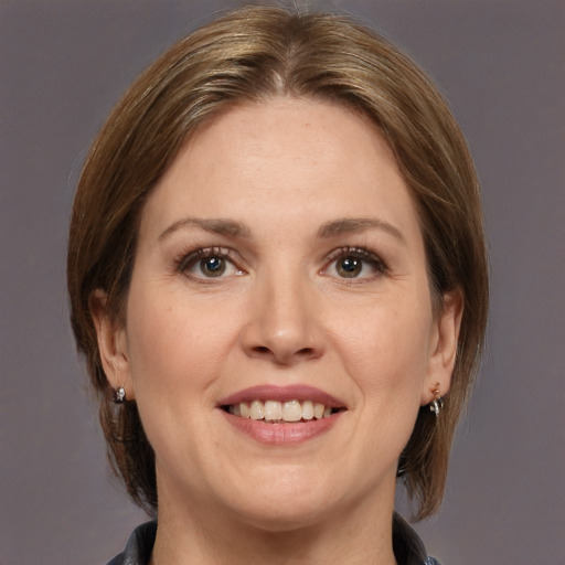 Joyful white adult female with medium  brown hair and grey eyes