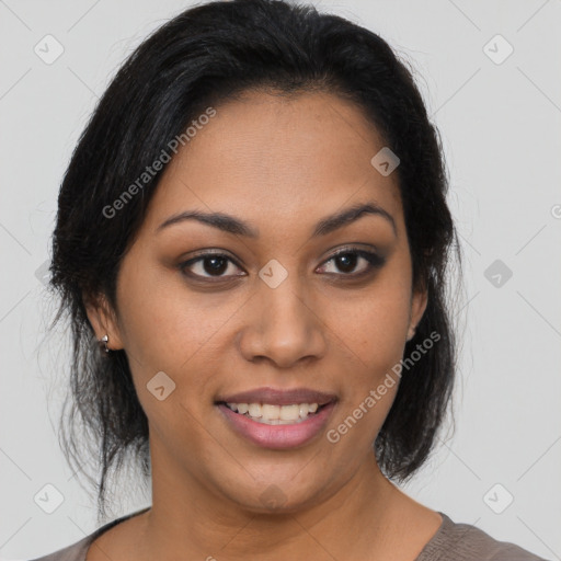 Joyful latino young-adult female with medium  brown hair and brown eyes