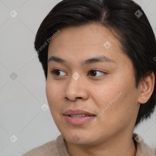 Joyful asian young-adult female with short  brown hair and brown eyes