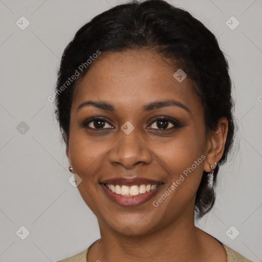 Joyful black young-adult female with long  black hair and brown eyes