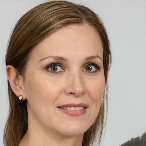 Joyful white young-adult female with medium  brown hair and green eyes