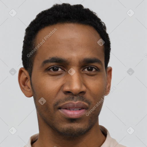 Joyful black young-adult male with short  black hair and brown eyes