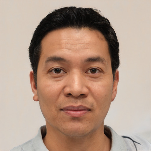 Joyful white adult male with short  black hair and brown eyes