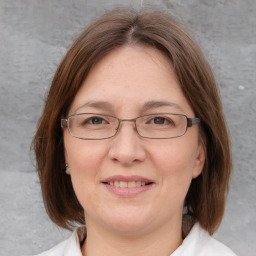 Joyful white adult female with medium  brown hair and blue eyes