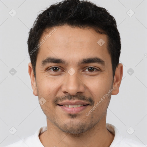 Joyful white young-adult male with short  black hair and brown eyes