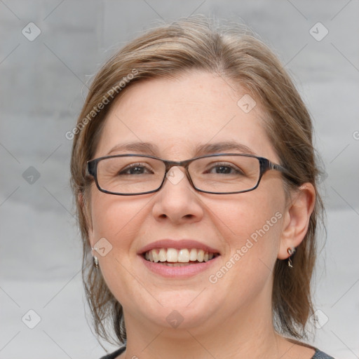 Joyful white adult female with medium  brown hair and blue eyes