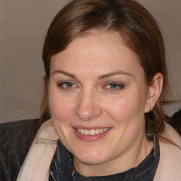 Joyful white adult female with medium  brown hair and brown eyes