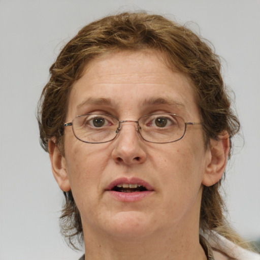 Joyful white adult female with medium  brown hair and green eyes