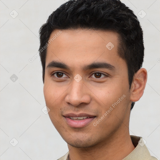 Joyful latino young-adult male with short  black hair and brown eyes