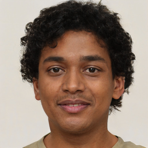 Joyful latino young-adult male with short  brown hair and brown eyes