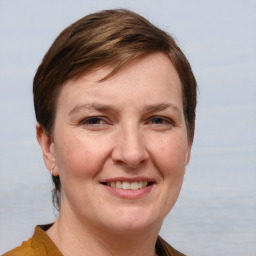 Joyful white adult female with medium  brown hair and grey eyes