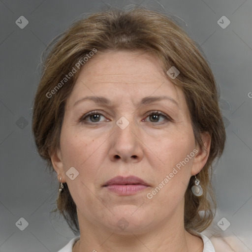 Joyful white adult female with medium  brown hair and grey eyes