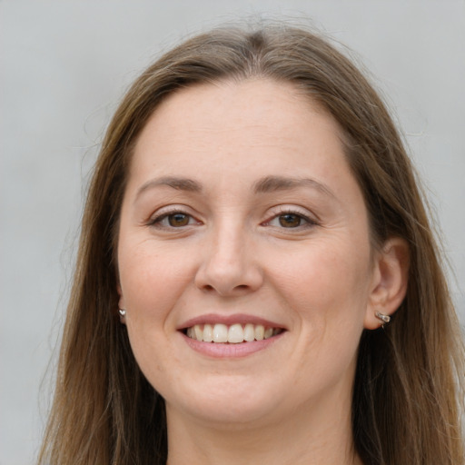 Joyful white young-adult female with long  brown hair and grey eyes