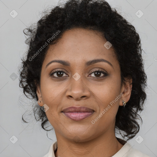 Joyful black adult female with medium  brown hair and brown eyes