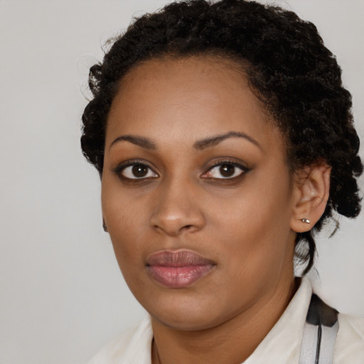 Neutral black young-adult female with medium  brown hair and brown eyes