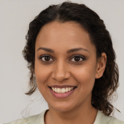 Joyful black young-adult female with medium  brown hair and brown eyes