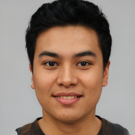 Joyful asian young-adult male with short  black hair and brown eyes