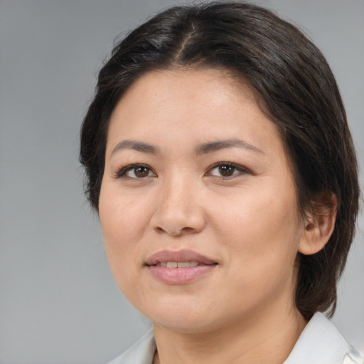Joyful white adult female with medium  brown hair and brown eyes
