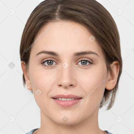 Joyful white young-adult female with medium  brown hair and grey eyes