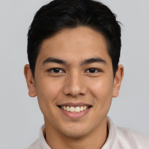 Joyful latino young-adult male with short  brown hair and brown eyes