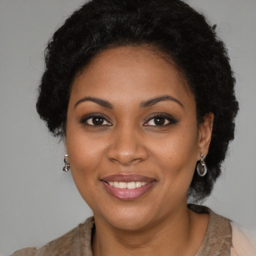 Joyful black young-adult female with medium  brown hair and brown eyes