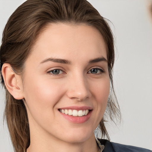 Joyful white young-adult female with medium  brown hair and grey eyes