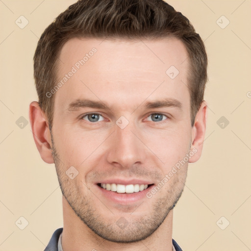 Joyful white young-adult male with short  brown hair and grey eyes