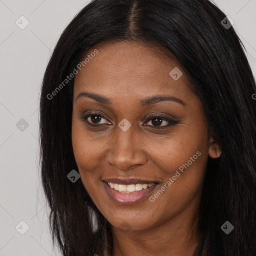 Joyful black young-adult female with long  black hair and brown eyes