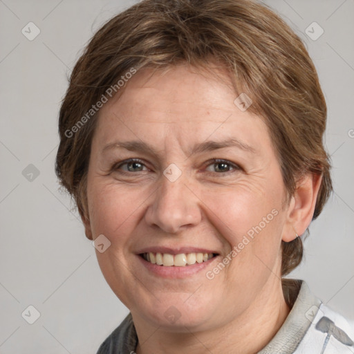 Joyful white adult female with medium  brown hair and grey eyes