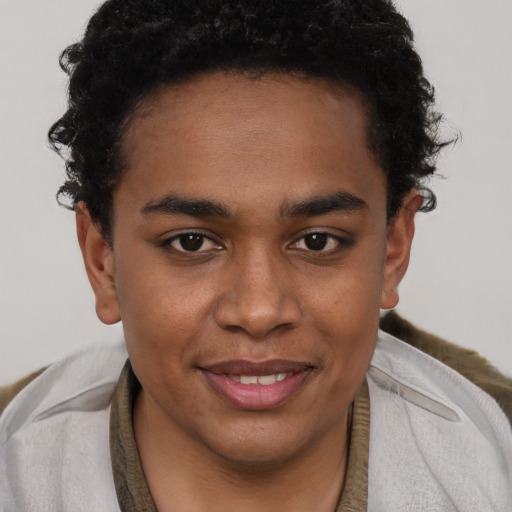 Joyful black young-adult male with short  brown hair and brown eyes
