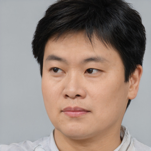 Neutral asian young-adult male with short  brown hair and brown eyes