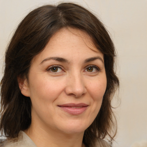 Joyful white adult female with medium  brown hair and brown eyes