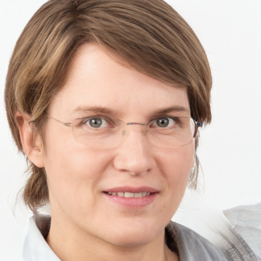 Joyful white adult female with medium  brown hair and blue eyes