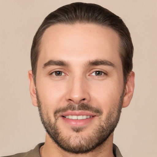 Joyful white young-adult male with short  brown hair and brown eyes