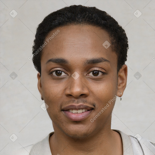 Joyful black young-adult male with short  black hair and brown eyes