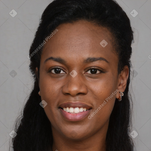 Joyful black young-adult female with long  black hair and brown eyes