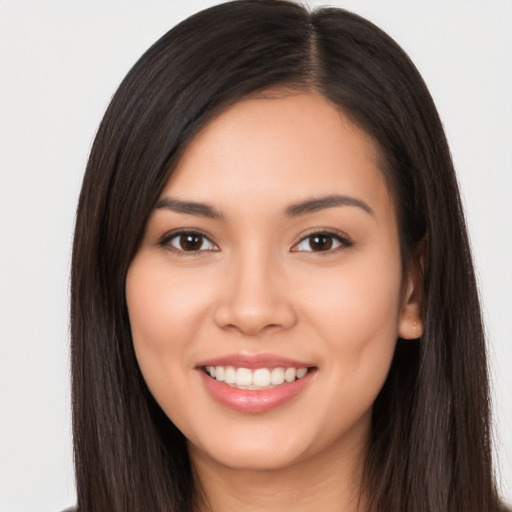 Joyful white young-adult female with long  black hair and brown eyes