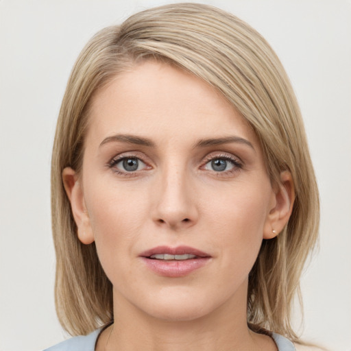 Joyful white young-adult female with medium  brown hair and blue eyes