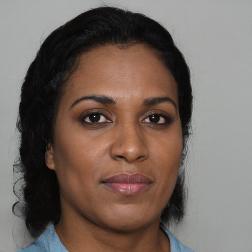 Joyful black young-adult female with medium  brown hair and brown eyes