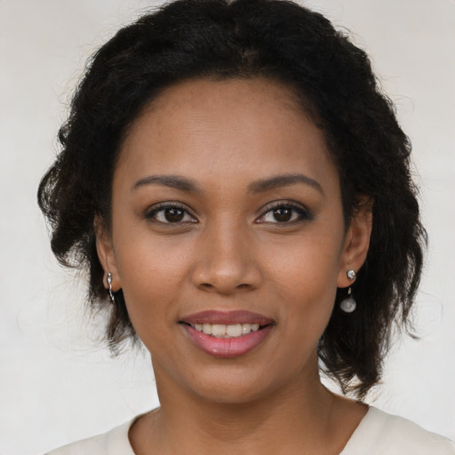 Joyful black young-adult female with medium  brown hair and brown eyes