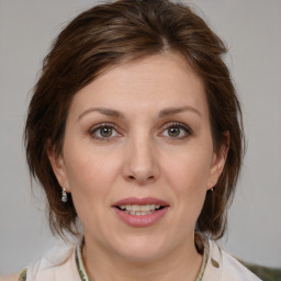 Joyful white young-adult female with medium  brown hair and blue eyes