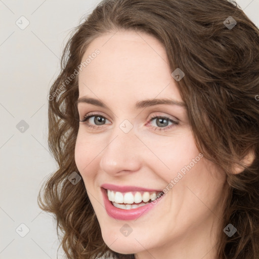 Joyful white young-adult female with medium  brown hair and green eyes