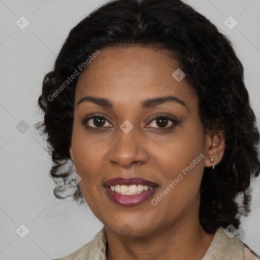 Joyful black young-adult female with long  brown hair and brown eyes